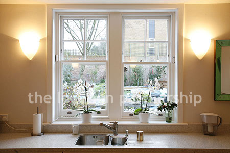 Spacious modern kitchen with island in large ground floor flat.