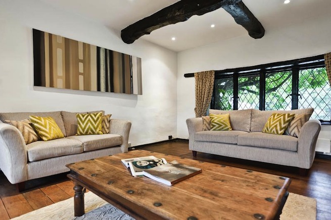 Large architect designed family home with original floor to ceiling log fireplace and 16th century beams. Backs onto woodland.