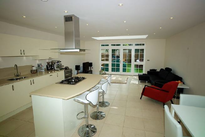 Contemporary clean lined kitchen, with central island hob.