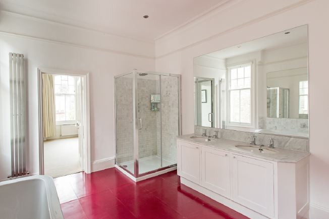 Spacious, modern bathroom with bath and shower units.