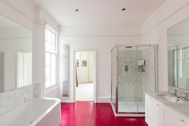 Spacious, modern bathroom with bath and shower units.