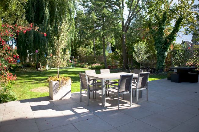 Large terrace and mature garden mainly laid to lawn with a large weeping willow tree. A covered walkway leads to an all purpose built eco-designed home office.