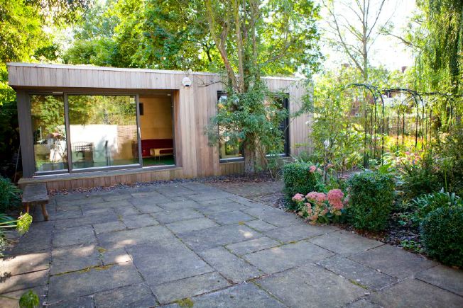 Large terrace and mature garden mainly laid to lawn with a large weeping willow tree. A covered walkway leads to an all purpose built eco-designed home office.