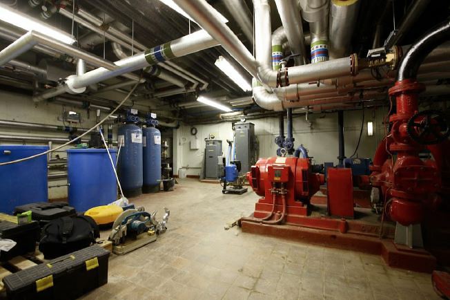 Subterranean network of corridors, tunnels and rooms with industrial pipes and features.