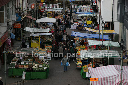 Vibrant street market seen from overhead bridge