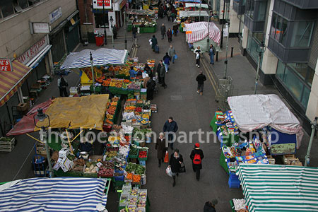 Vibrant street market seen from overhead bridge