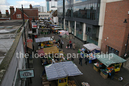 Vibrant street market seen from overhead bridge