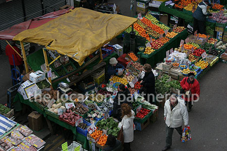 Vibrant street market seen from overhead bridge