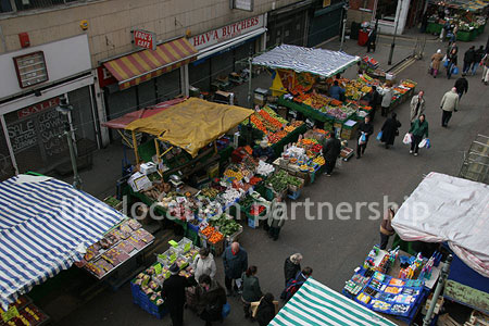 Vibrant street market seen from overhead bridge