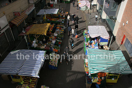 Vibrant street market seen from overhead bridge
