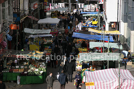 Vibrant street market seen from overhead bridge