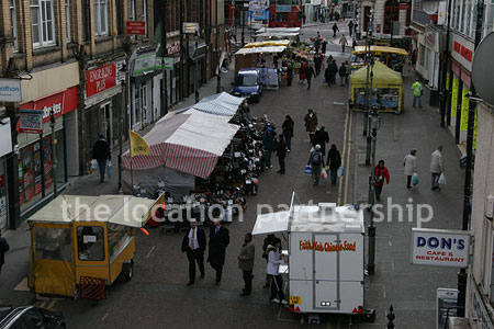 Vibrant street market seen from overhead bridge