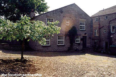 Small cobbled square surrounded by period houses.