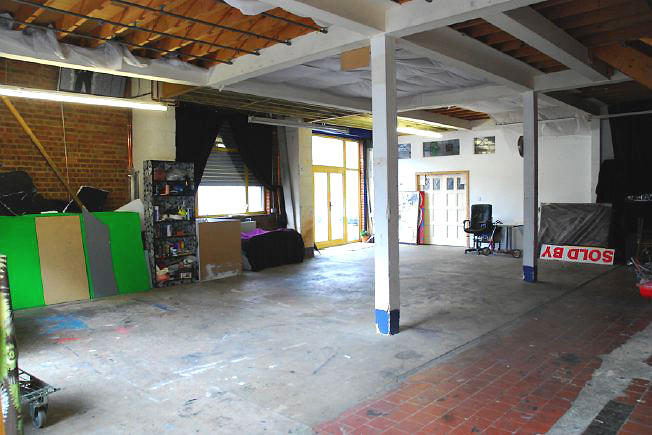 Bright, spacious 1,200 sq ft warehouse conversion with living area and studio space. The studio space is glass fronted with shutters and can be blacked out. NB- ceiling is now solid - no beams.