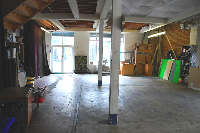 Bright, spacious 1,200 sq ft warehouse conversion with living area and studio space. The studio space is glass fronted with shutters and can be blacked out. NB- ceiling is now solid - no beams.