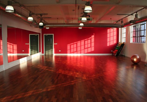 Fitness/ dance studio with warehouse windows letting in lots of natural light. Situated on the third floor.
