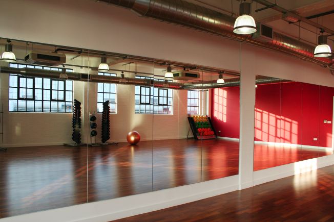 Fitness/ dance studio with warehouse windows letting in lots of natural light. Situated on the third floor.