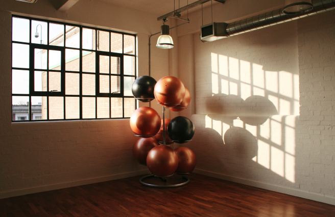 Fitness/ dance studio with warehouse windows letting in lots of natural light. Situated on the third floor.