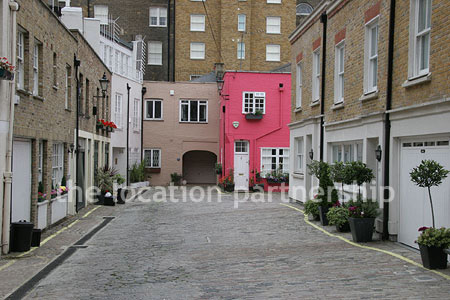 Cobbled mews with some loudly painted houses