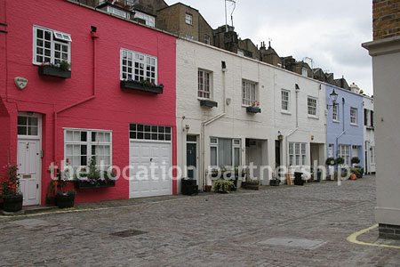 Cobbled mews with some loudly painted houses