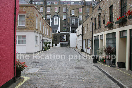 Cobbled mews with some loudly painted houses