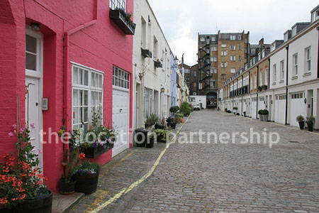 Cobbled mews with some loudly painted houses