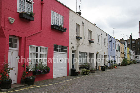 Cobbled mews with some loudly painted houses