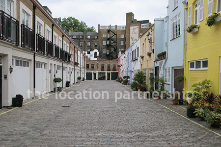 Cobbled mews with some loudly painted houses