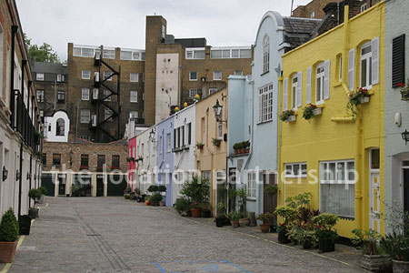Cobbled mews with some loudly painted houses