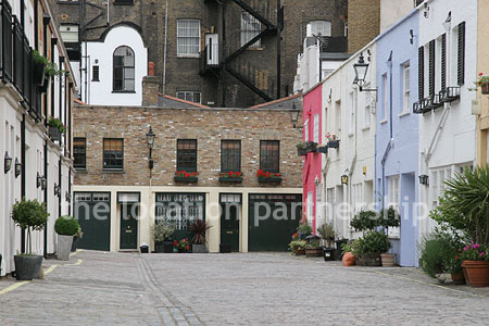 Cobbled mews with some loudly painted houses