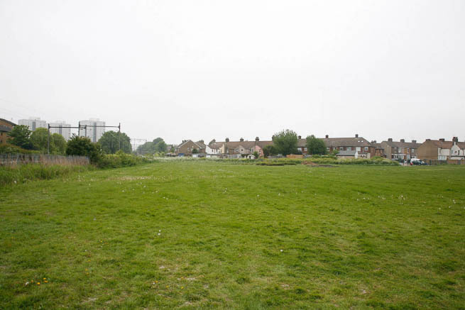 Football pitch on large recreation ground with great urban backdrop.