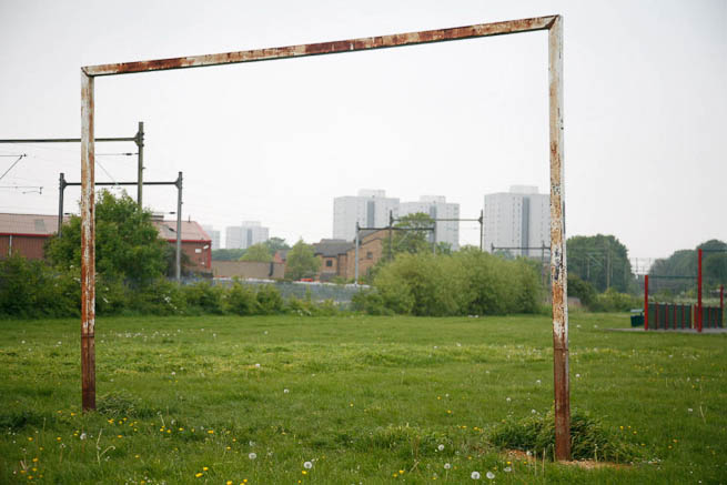 Football pitch on large recreation ground with great urban backdrop.