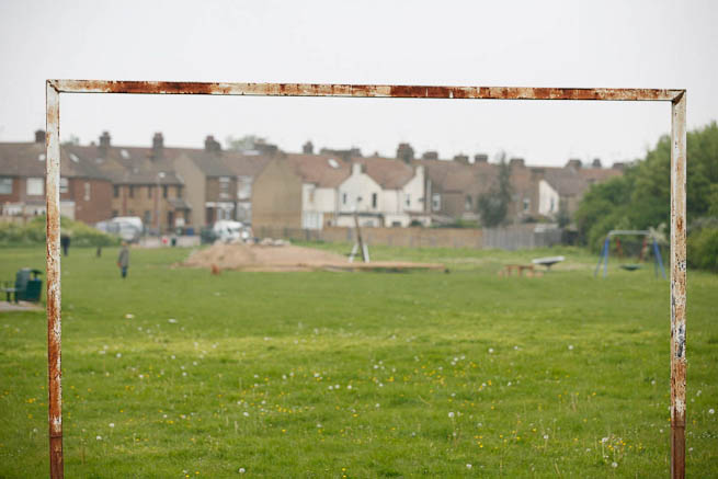 Football pitch on large recreation ground with great urban backdrop.