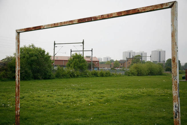 Football pitch on large recreation ground with great urban backdrop.