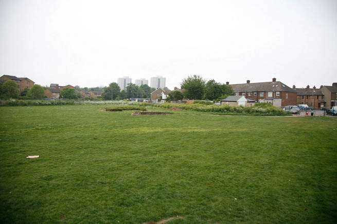 Football pitch on large recreation ground with great urban backdrop.