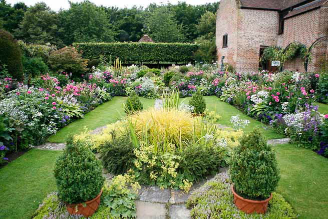 Gardens of a Tudor Manor house divided into compartments with different colour themes and structural forms.