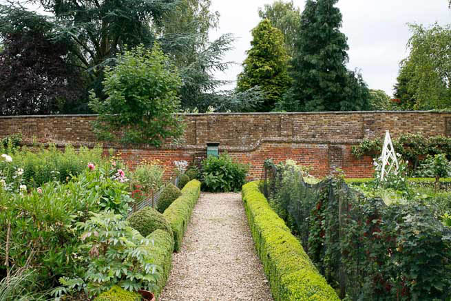 Gardens of a Tudor Manor house divided into compartments with different colour themes and structural forms.