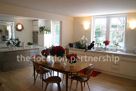 Spacious modern kitchen with island in large ground floor flat.