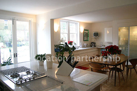 Spacious modern kitchen with island in large ground floor flat.
