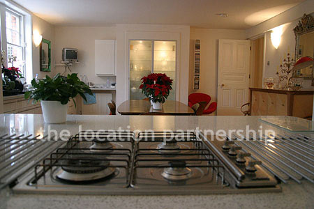 Spacious modern kitchen with island in large ground floor flat.
