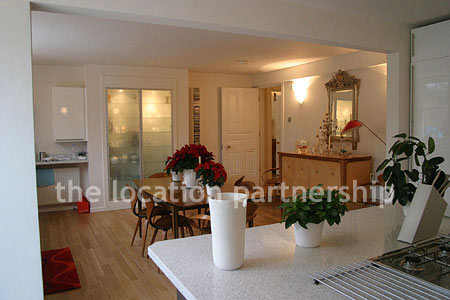 Spacious modern kitchen with island in large ground floor flat.