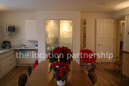 Spacious modern kitchen with island in large ground floor flat.
