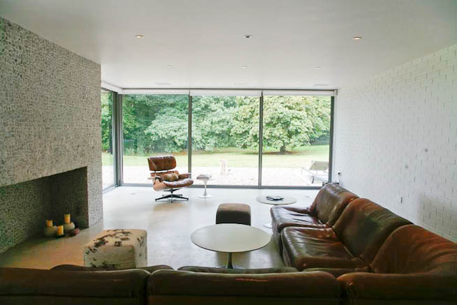 Large sitting room in contemporary country home. Large windows facing onto gardens and lots of natural light.
