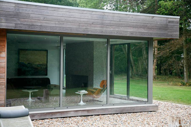 Large sitting room in contemporary country home. Large windows facing onto gardens and lots of natural light.
