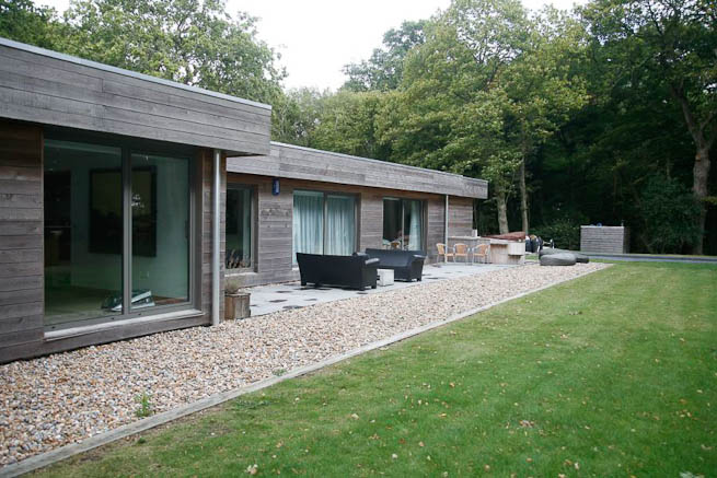Large sitting room in contemporary country home. Large windows facing onto gardens and lots of natural light.