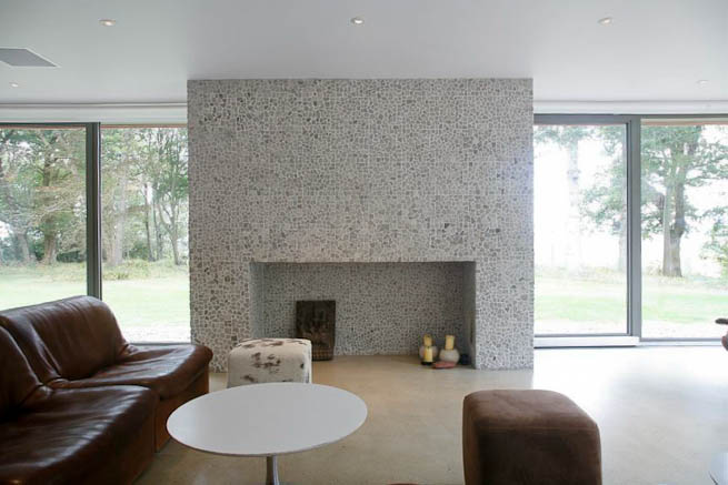 Large sitting room in contemporary country home. Large windows facing onto gardens and lots of natural light.