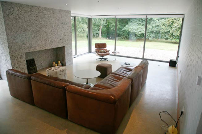 Large sitting room in contemporary country home. Large windows facing onto gardens and lots of natural light.