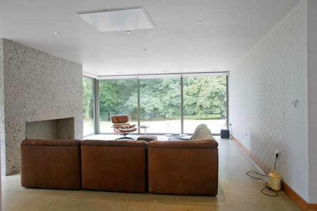 Large sitting room in contemporary country home. Large windows facing onto gardens and lots of natural light.