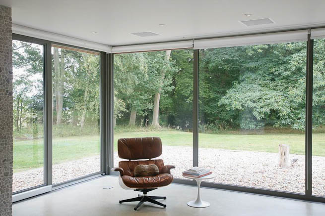 Large sitting room in contemporary country home. Large windows facing onto gardens and lots of natural light.