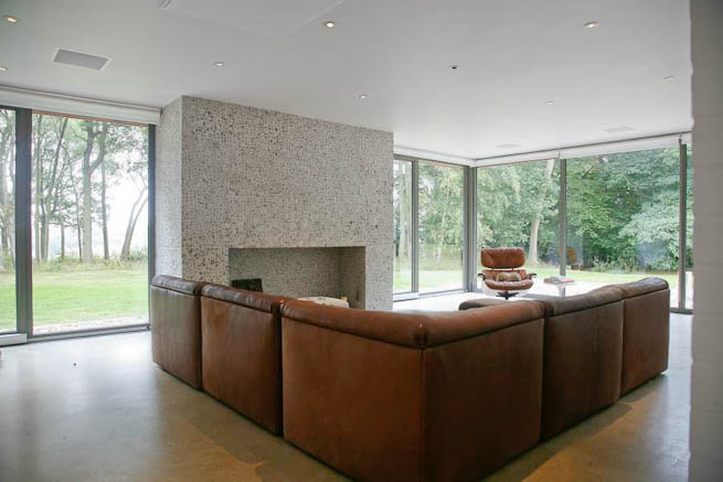 Large sitting room in contemporary country home. Large windows facing onto gardens and lots of natural light.